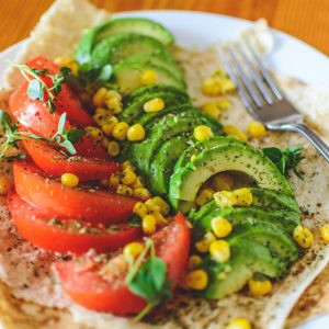 Sliced Tomato and Avocado on White Plate