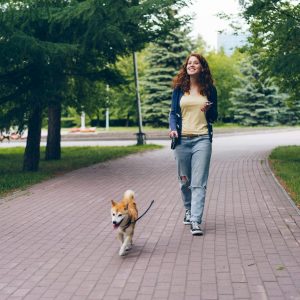 Smiling Woman with Dog at Park