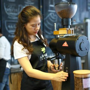 Woman Grinding Coffee Bean