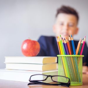 Boy Looking On A Tidied Desk