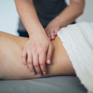 Person Lying in Bed Getting Massage